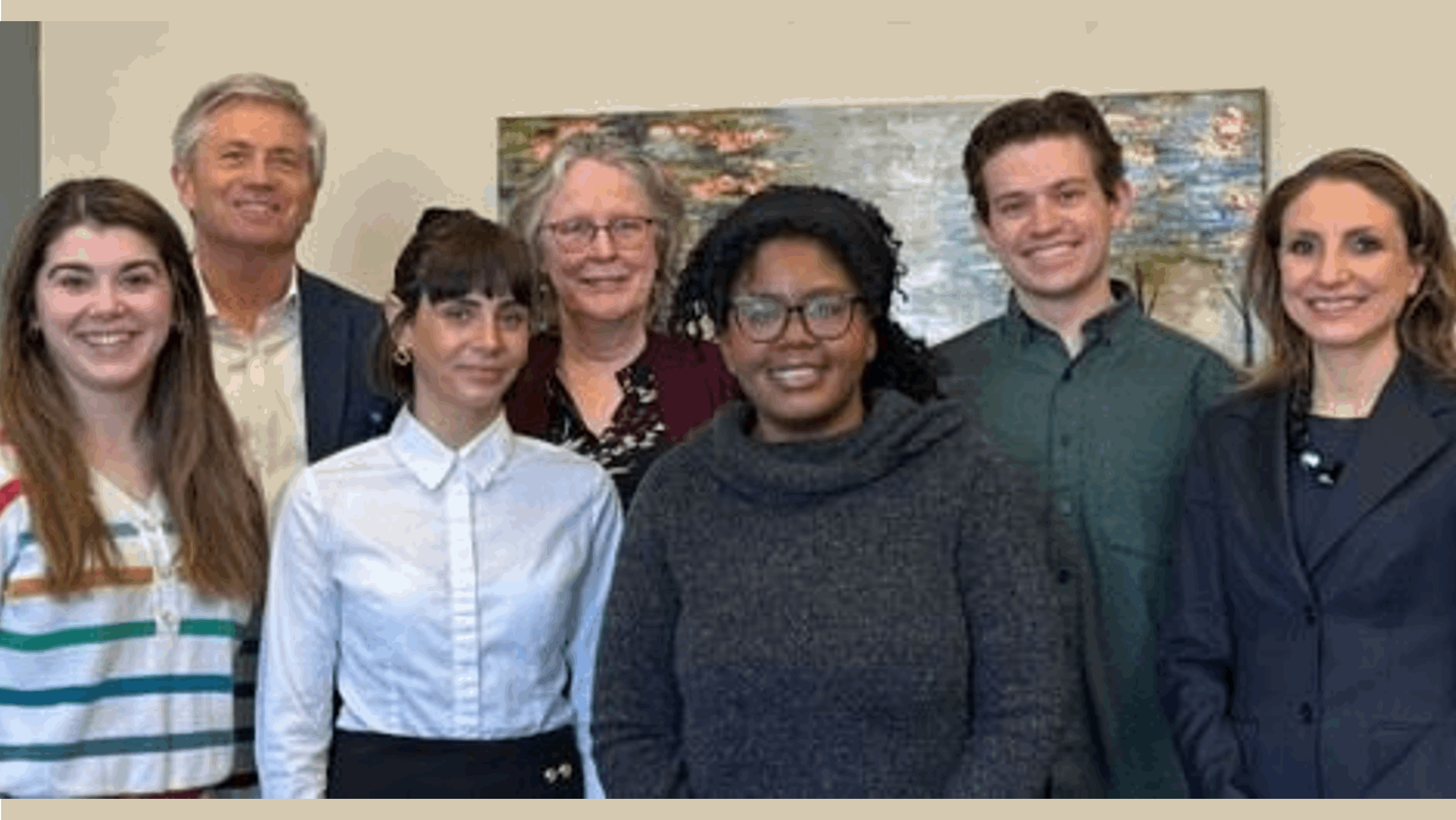 A group of diverse research staff standing in a group and smiling