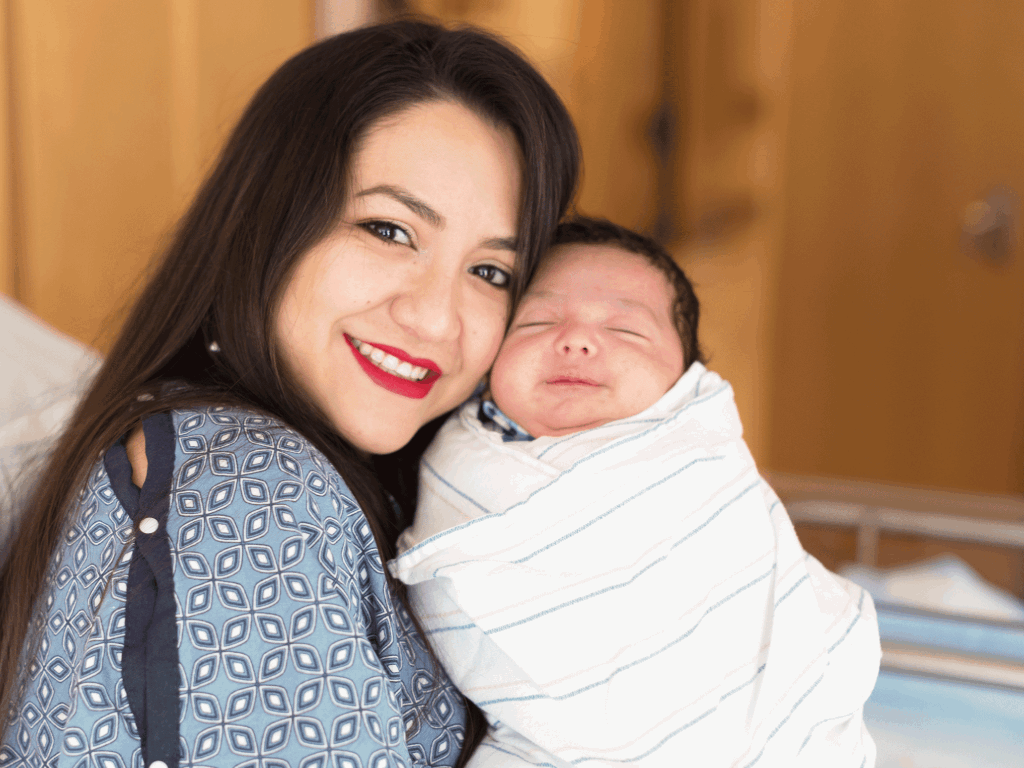 Happy mother with her newborn baby in the hospital.